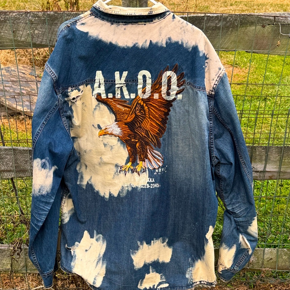 Akoo Distressed Denim Shirt Jacket with Eagle Graphic and raised designs.
